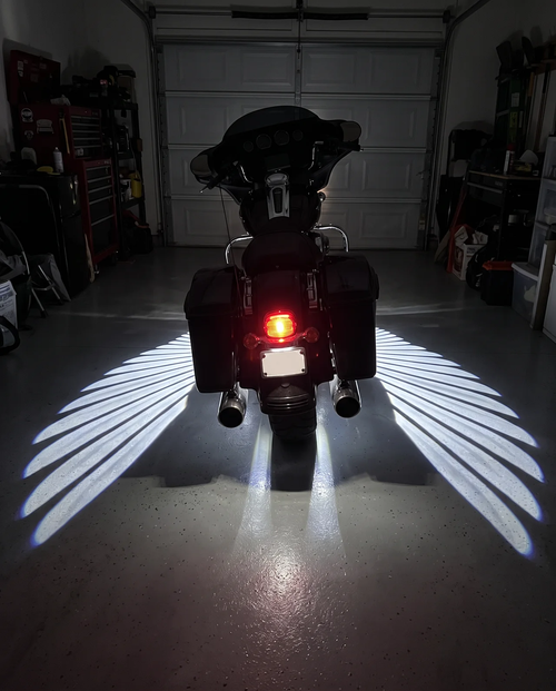 Angel White wings under a bagger in a garage