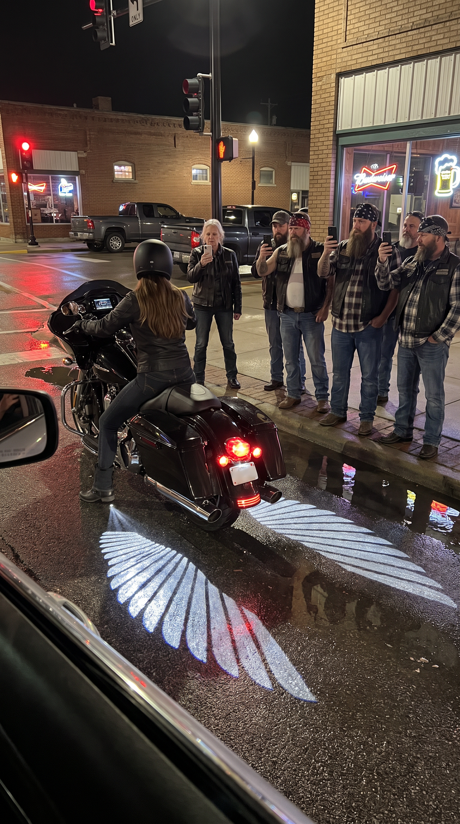 Riders filming the angel wings outside a bar