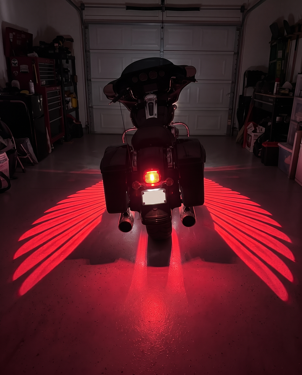 Racing Red wings under a bagger in a garage